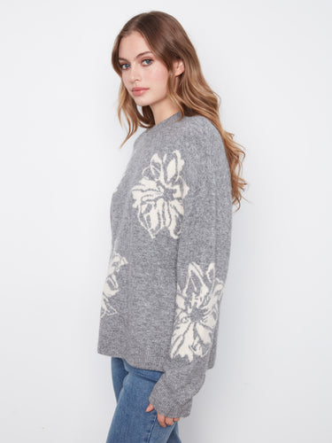 Long sleeves adorned with elegant floral designs add charm to this comfortable sweater by Charlie B.