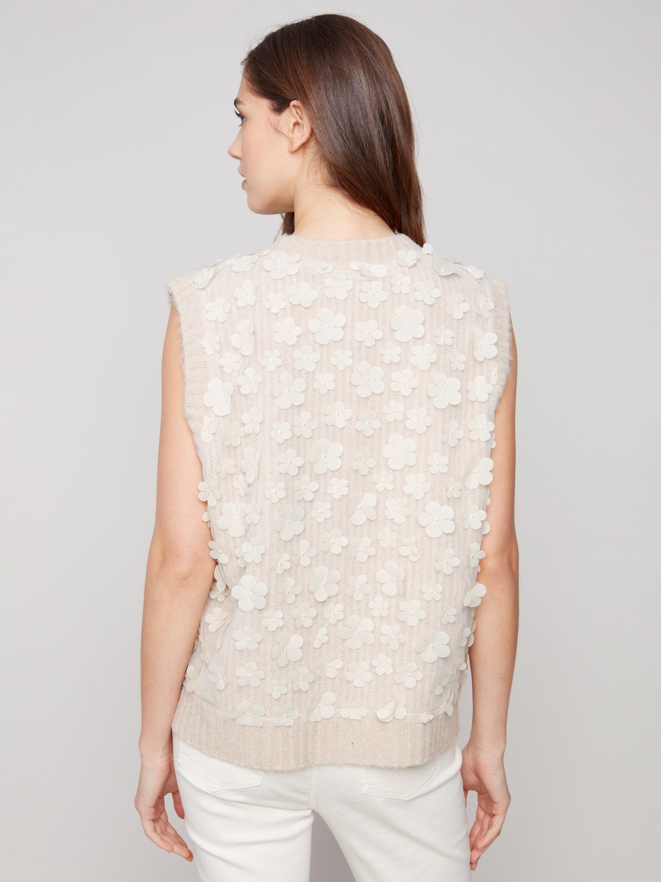 Heather oat color beautifully complements the intricate floral mesh details on this vest by Charlie B.