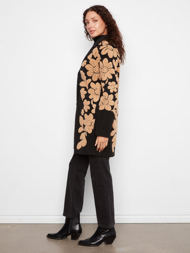 Elegant sherpa floral motifs embellish this chic coat, offering a unique and fashionable look. By Charlie B.