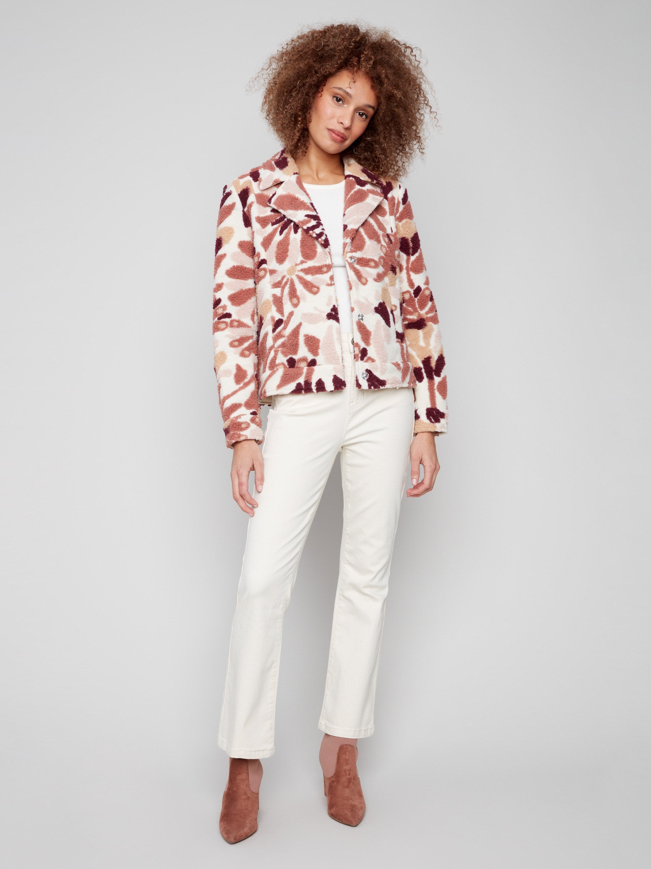 Chic floral sherpa fleece coat with open sleeve cuffs that add a modern flair to your outfit by Charlie B.