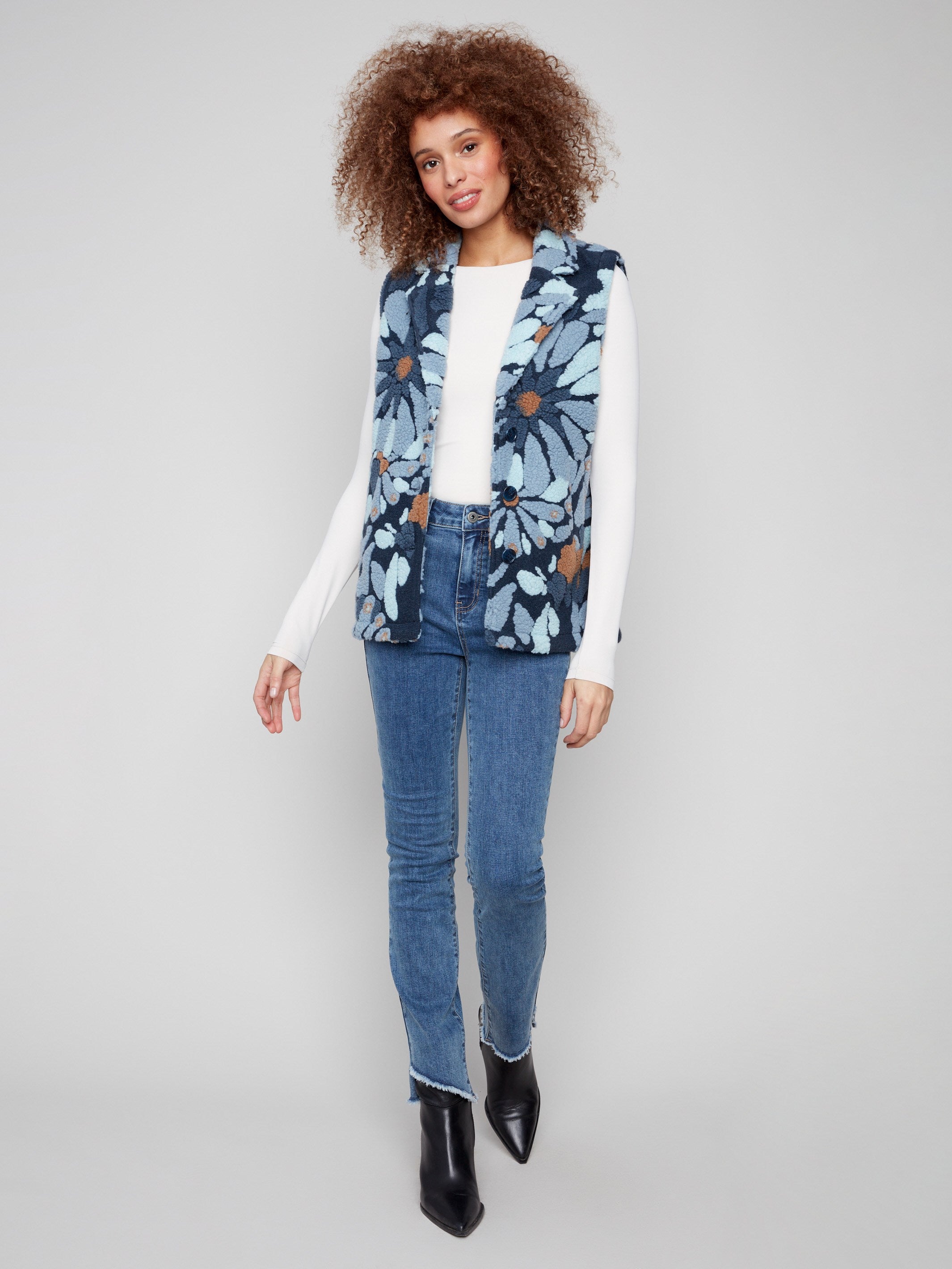 Blue floral vest with cozy Sherpa fleece, featuring a stylish spread collar for added elegance by Charlie B.
