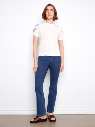 Enjoy the soft feel of this 100% cotton knit top, complete with charming floral details on the short sleeves by Charlie B.