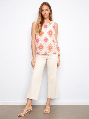 A trendy sleeveless top adorned with colorful flowers, offering both style and breathability. Crew neckline completes the look. By Charlie B.
