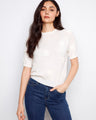 White cotton knit top featuring raglan sleeves and floral soutache, styled with jeans by Charlie B.