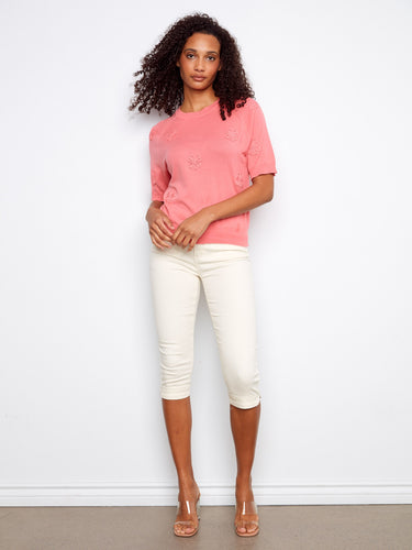 Comfortable pink top with classic crew neckline design, crafted entirely from high-quality cotton. By Charlie B.