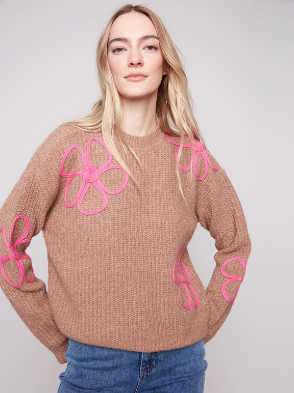 Embrace comfort with this crew neck sweater showcasing pink floral patterns and a relaxed fit by Charlie B.
