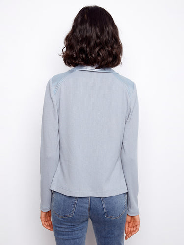 Elegant light blue jacket showcasing rib knit sleeves and back, combined with sleek faux leather finish by Charlie B.