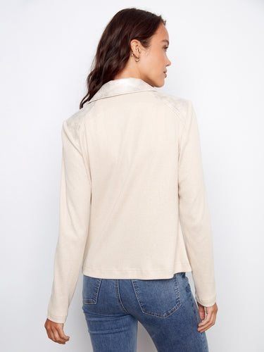 Rib knit sleeves and back provide comfort and flexibility to this fashion-forward piece. By Charlie B.
