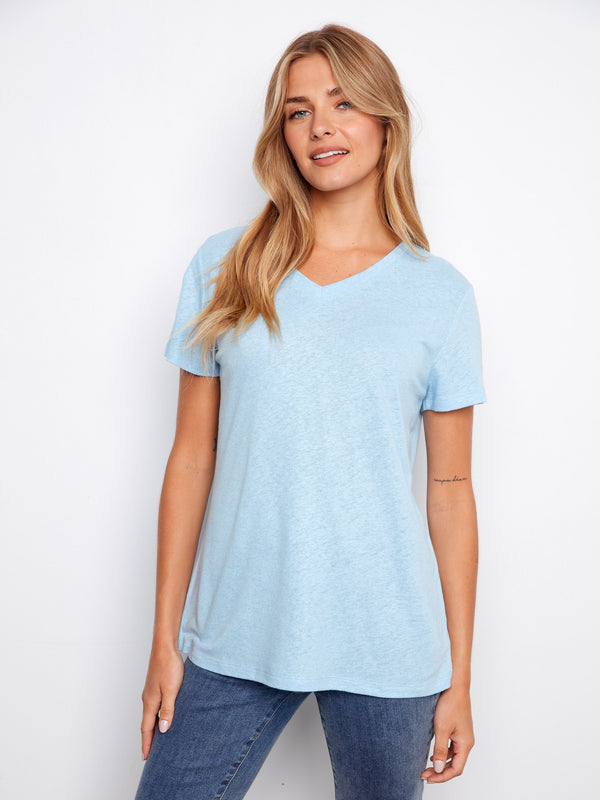 Light blue V-neck shirt with a relaxed fit and short sleeves, perfect for casual outings. By Charlie B.