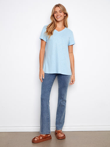 Chic light blue top featuring a foiled sheen and comfortable short sleeves, ideal for everyday wear. By Charlie B.