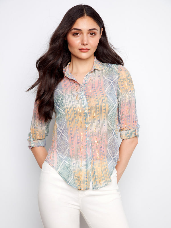 The gold print details on this shirt bring a subtle shimmer to the semi-sheer crinkle fabric, enhancing its elegance by Charlie B.