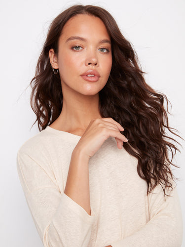 Sophisticated 3/4 sleeve top with a soft V-neckline and a touch of shimmer from the foiled finish. By Charlie B.