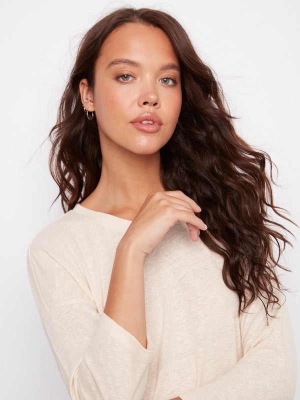 Sophisticated 3/4 sleeve top with a soft V-neckline and a touch of shimmer from the foiled finish. By Charlie B.