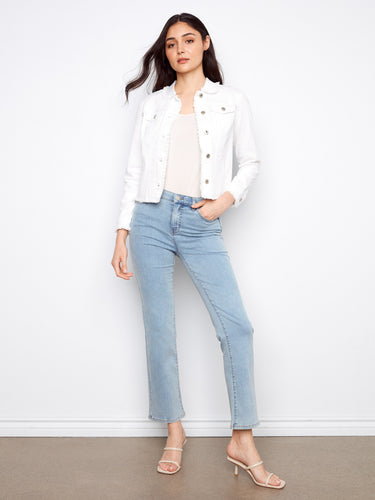 White jean jacket with button front and stylish design, paired with light jeans for a chic look by Charlie B.