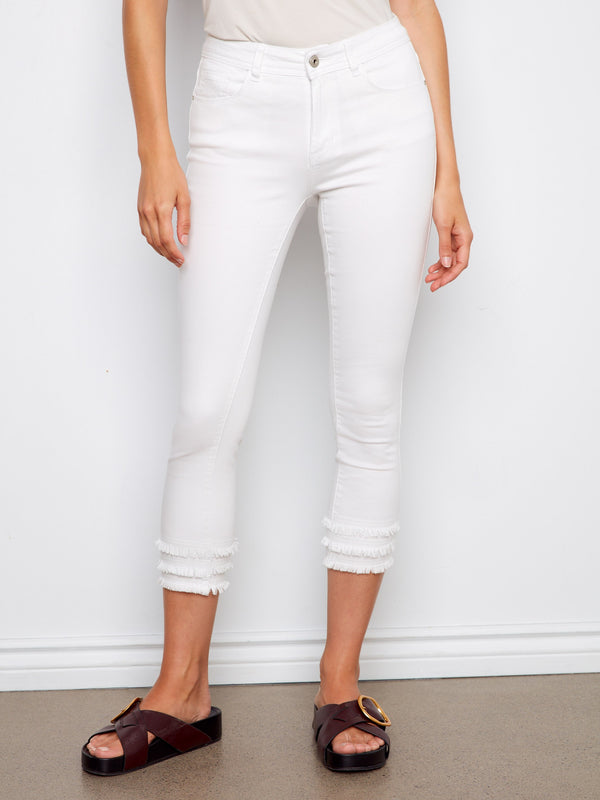 Cropped white pants featuring a five-pocket design and frayed hem details, crafted from stretch twill by Charlie B.