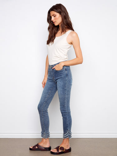 Experience ultimate comfort with the soft, stretchy denim of these trendy skinny fit jeans with frayed hems by Charlie B.