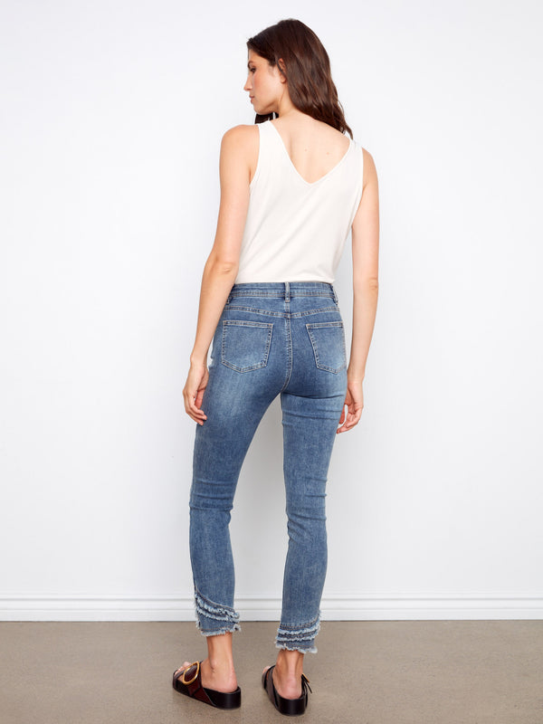 With unique frayed hem detail, these denim pants stand out with effortless chic appeal. By Charlie B.