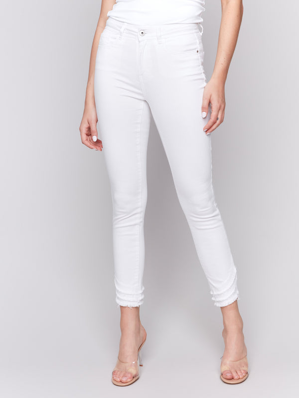 White slim fit twill pants with a frayed hem, ankle-length and mid-rise design by Charlie B.
