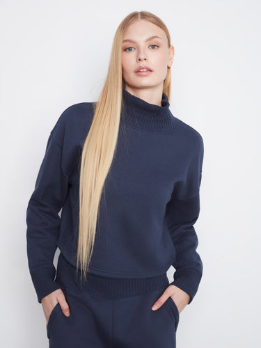 Navy sweater designed with long sleeves and ribbed accents, providing both comfort and style by Charlie B.