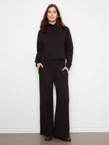 Elegant black top featuring a cotton blend material and ribbed details for added style by Charlie B.