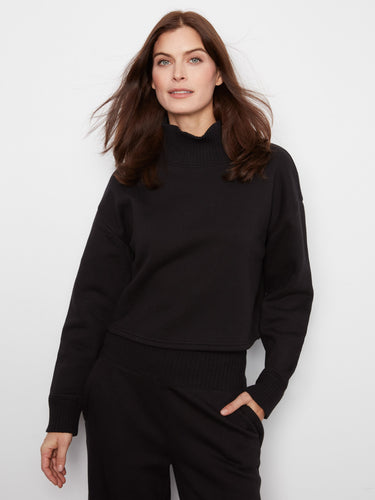 Sophisticated black French terry top showcasing ribbed neck and cuffs for a refined look by Charlie B.