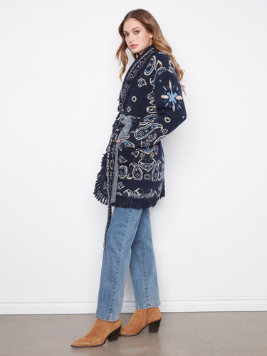 Stylish navy blue cardigan featuring fringe details, geometric jacquard pattern, and a chic shawl collar by Charlie B.