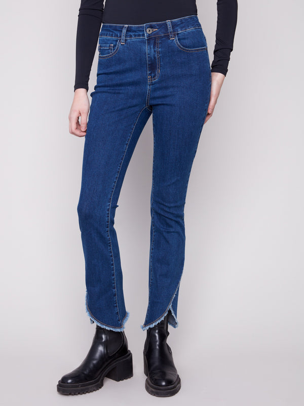 These jeans showcase a frayed hem detail, adding a touch of edge to the classic indigo design by Charlie B.