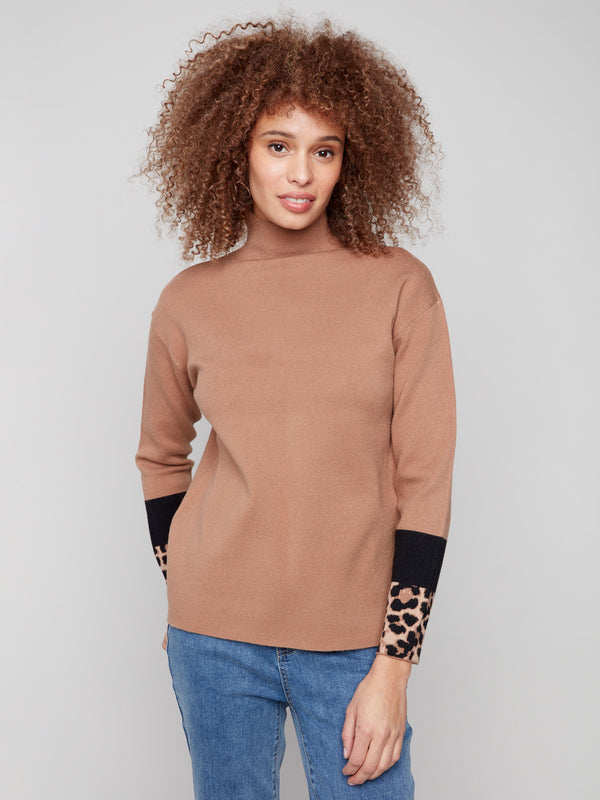 Sweater with a chic funnel neck and animal print sleeves, offering a modern look by Charlie B.