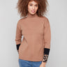 Sweater with a chic funnel neck and animal print sleeves, offering a modern look by Charlie B.