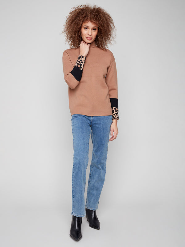 Elegant long-sleeved sweater featuring stylish color-block animal print details by Charlie B.