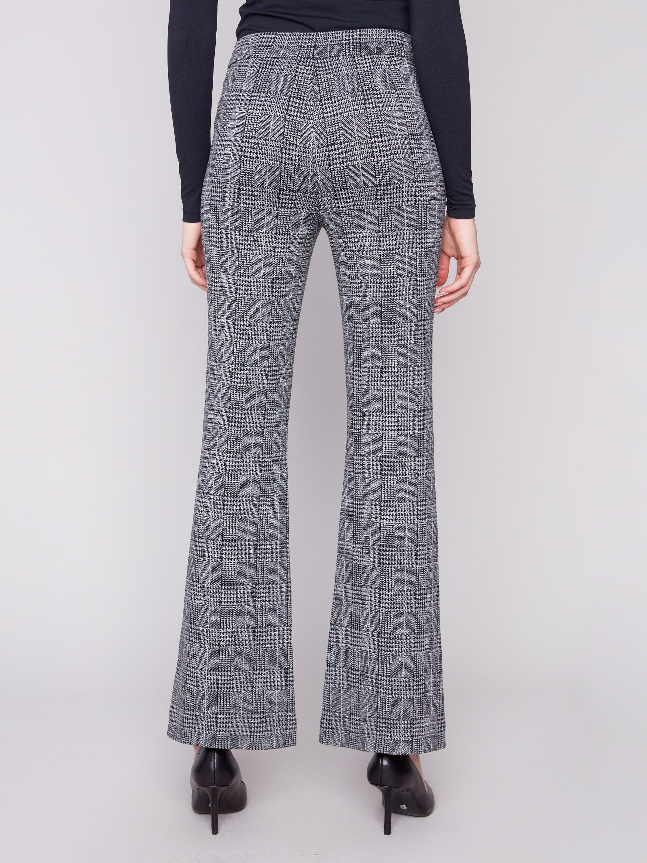 Crafted from stretch fabric, these charcoal glen plaid flare pants ensure comfort without compromising on style by Charlie B.