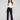 Black flare pants featuring long length, paired with a white top, by Charlie B.