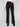 Stylish black flare pants showcasing welt pockets, worn with a white top, by Charlie B.
