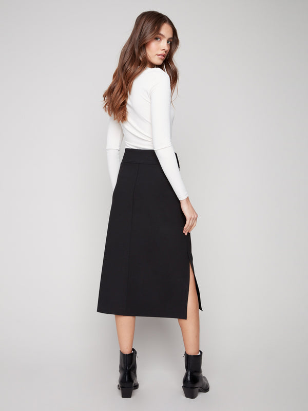Sleek black crepe skirt designed with side slits for added movement and flair by Charlie B.