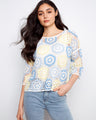 Featuring a stylish crew neckline, this top showcases a vibrant handcrafted crochet design in pastel hues. By Charlie B.