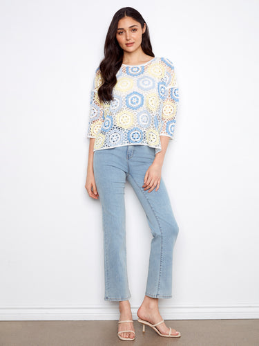 This top's exquisite handcrafted crochet design adds a unique touch to any outfit, perfect for casual elegance. By Charlie B.