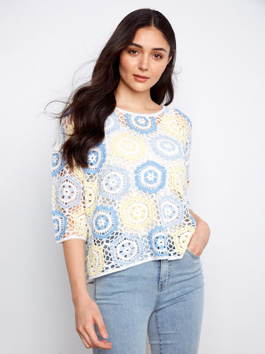 Designed with a classic crew neckline, this crochet top is ideal for layering or wearing alone on warm days. By Charlie B.