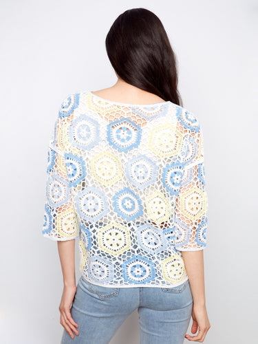 Enjoy the delicate beauty of the handcrafted crochet design in this versatile and chic fashion piece. By Charlie B.