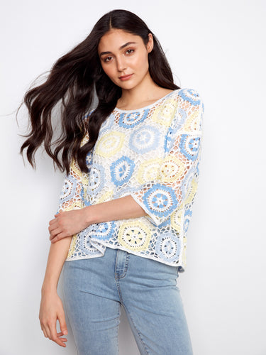 With its 3/4 sleeves and airy feel, this crocheted masterpiece is perfect for transitioning between seasons. By Charlie B.