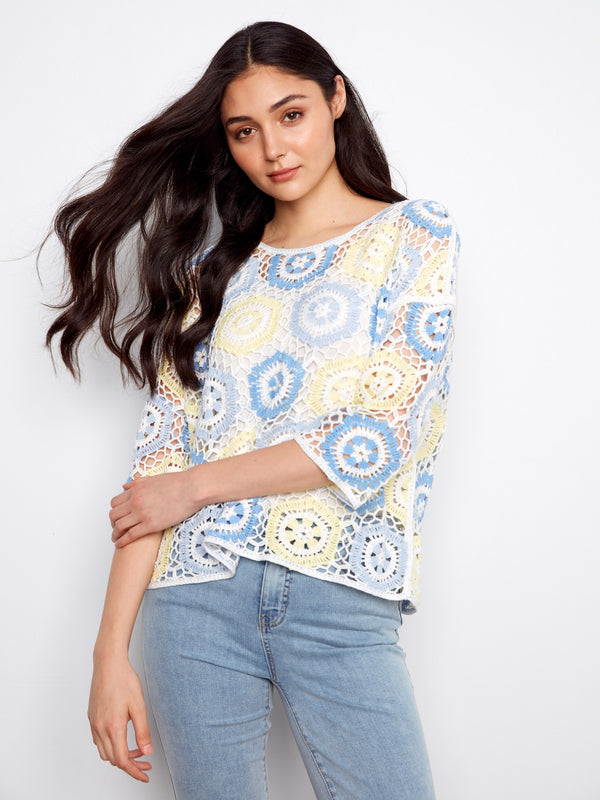 With its 3/4 sleeves and airy feel, this crocheted masterpiece is perfect for transitioning between seasons. By Charlie B.