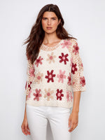 Elegant floral crochet top with a handcrafted design, featuring a crew neckline in carnation color by Charlie B.