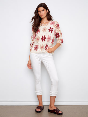 Charming crochet top in carnation with 3/4 sleeves, showcasing a delicate handcrafted pattern by Charlie B.