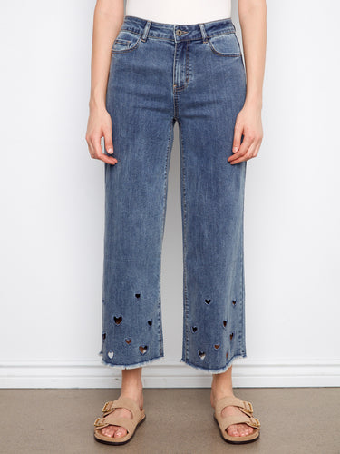 Stylish medium blue jeans with heart cutouts at the hem, crafted from stretch denim material for comfort by Charlie B.