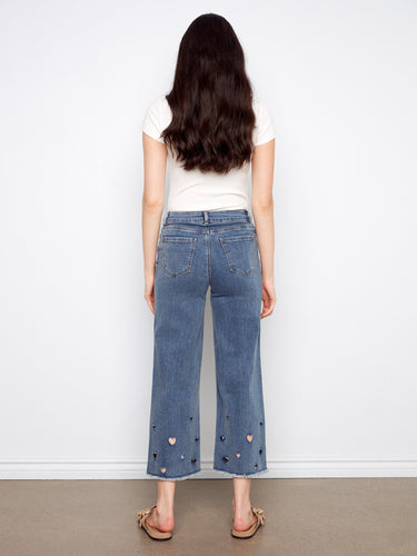 Chic medium blue wide-leg jeans with trendy cropped length and unique heart cutout detailing at the hem by Charlie B.