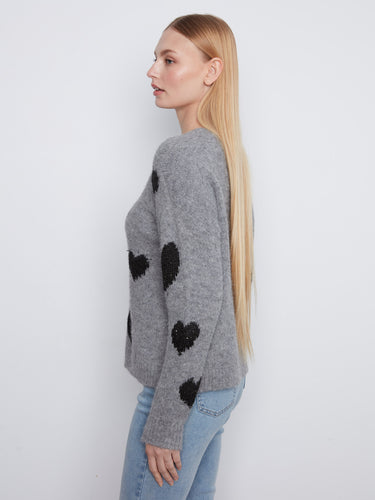 Long sleeves enhance the warmth of this grey sweater adorned with heart patterns by Charlie B.