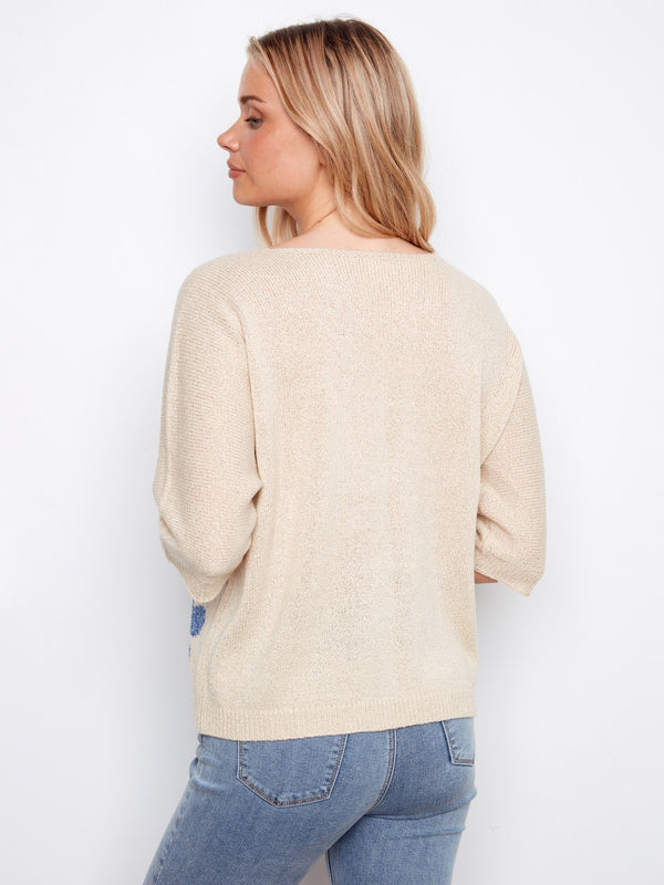 The V-neck sweater offers both comfort and chic appeal, ideal for layering or wearing alone. A must-have wardrobe staple by Charlie B.