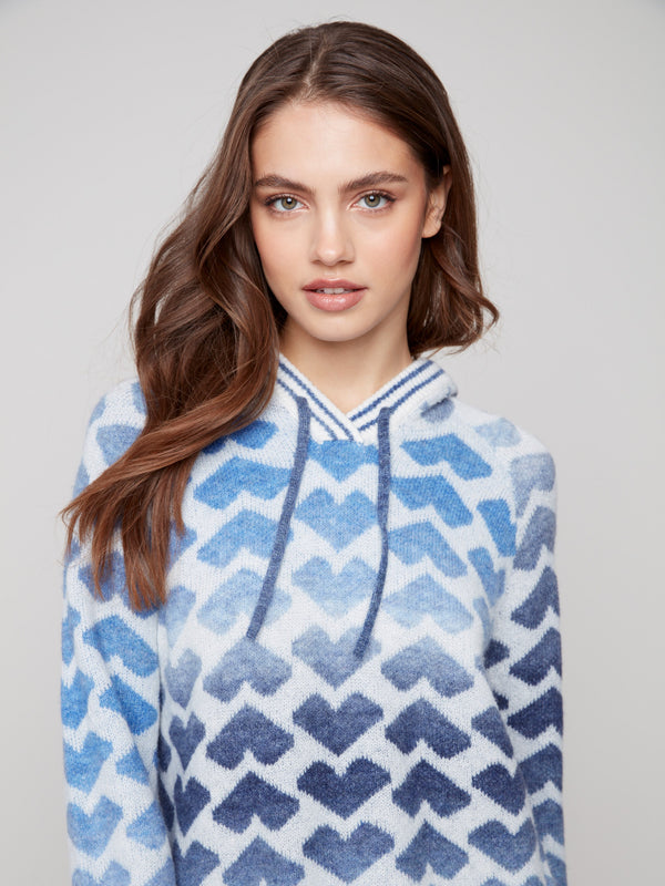 Charming sweater featuring raglan sleeves with a playful heart design by Charlie B.