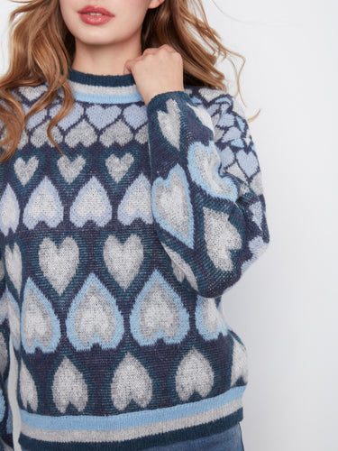 Elegant navy sweater adorned with heart jacquard pattern, complete with a stylish mock neck by Charlie B.