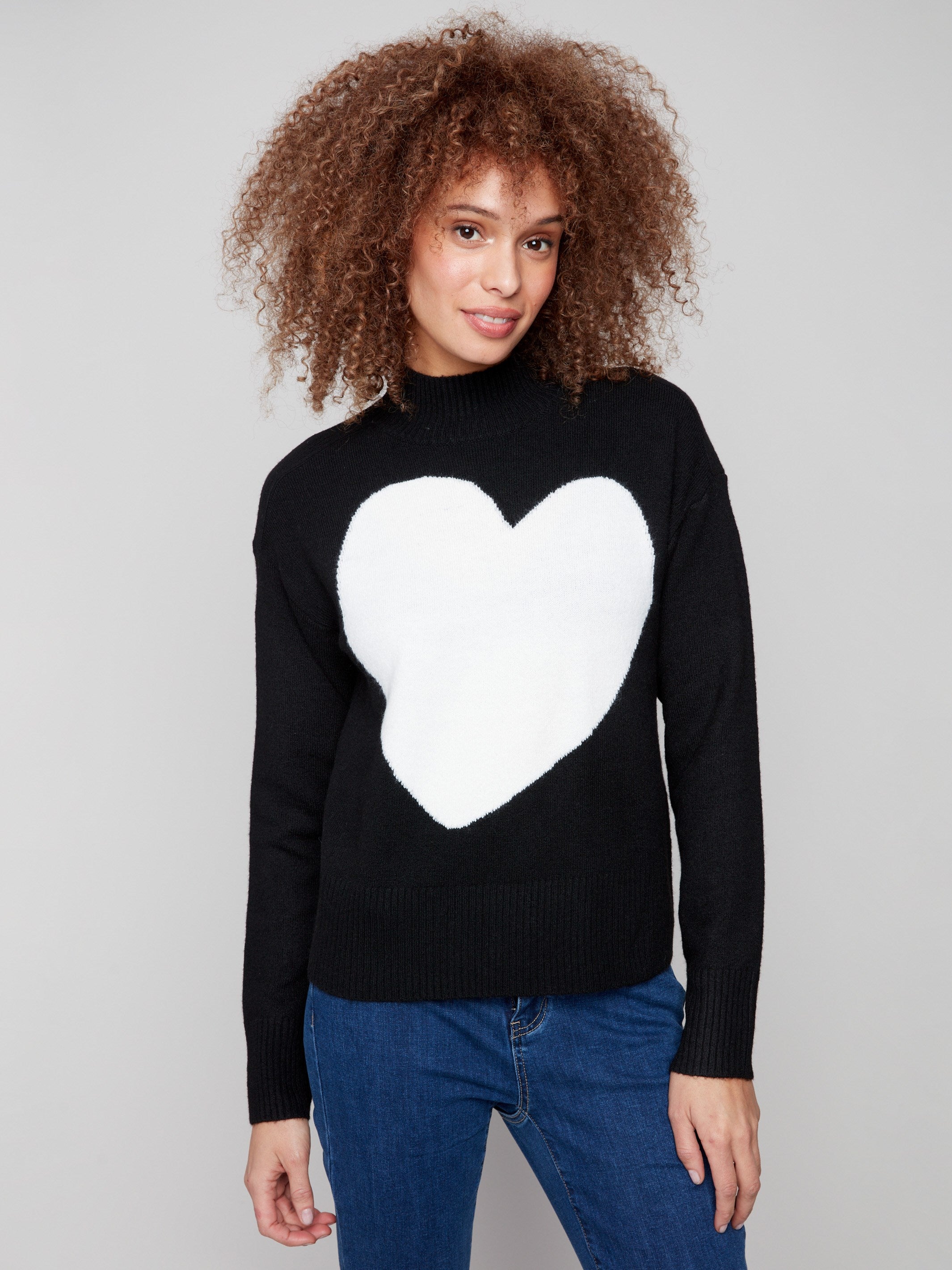 Sweater showcasing a ribbed mock neck and a striking white heart motif for a stylish touch by Charlie B.