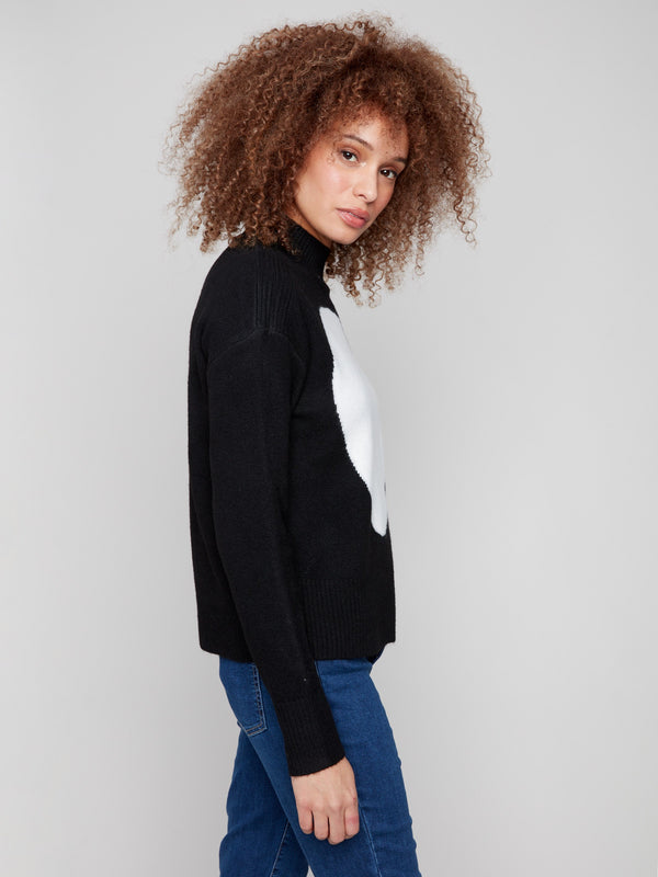 The drop shoulder design enhances the relaxed fit of this chic black sweater by Charlie B.